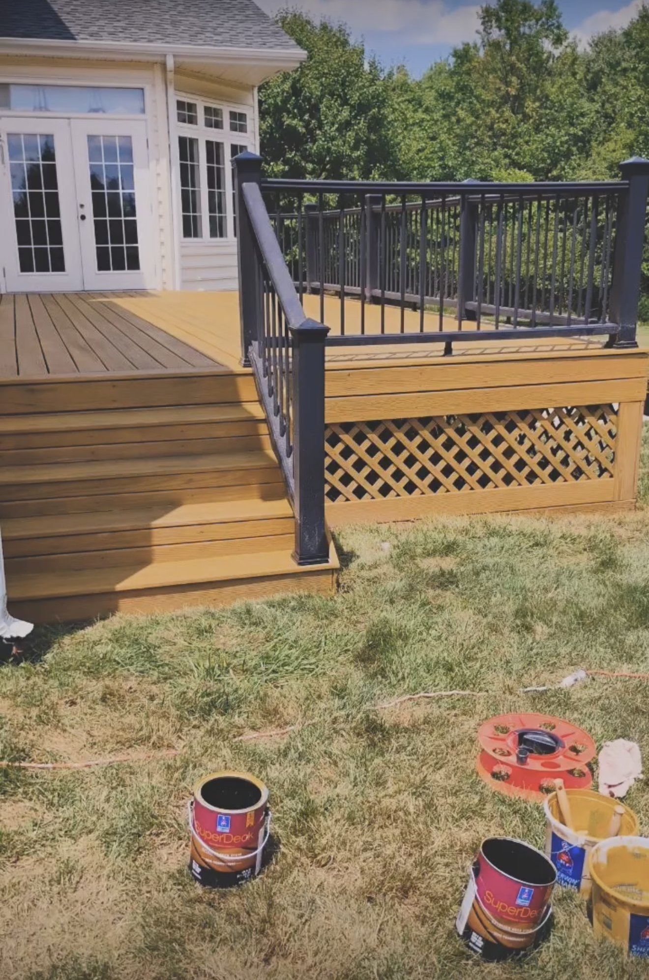 Restored deck in a warm stain with dark railings