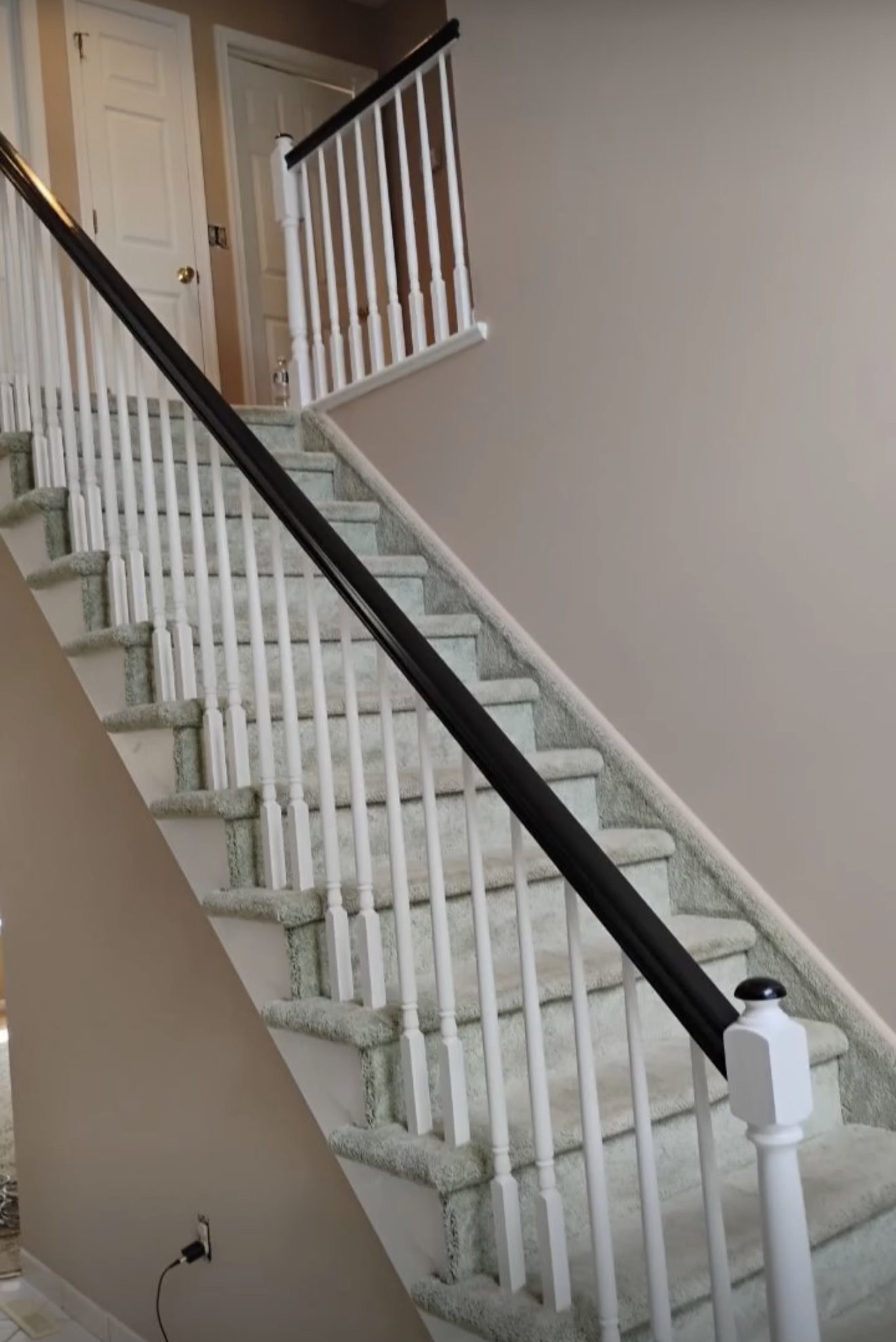 Stairway with white spindles and a dark railing